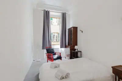 a bedroom with a white bed with two towels on it at Appartement Verrière - Welkeys in Nice