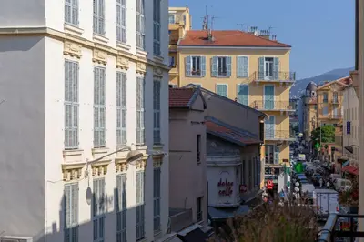 a view of a city street with buildings at 100m from the sea in Nice