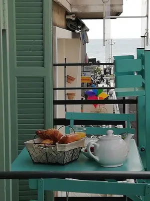 a table with a teapot and a bowl of bread at 100m from the sea in Nice