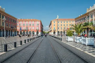 a street with train tracks in a city with buildings at 