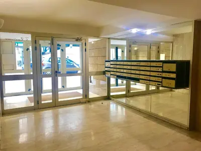 a large room with glass doors and a mirror at Studio Nice Centre garibaldi port plage in Nice