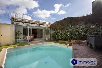a swimming pool in the backyard of a house at Air-conditioned house with private pool in Cagnes-sur-Mer