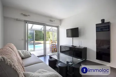 a living room with a couch and a flat screen tv at Air-conditioned house with private pool in Cagnes-sur-Mer
