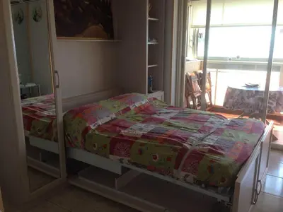a bed with a quilt on it in a bedroom at MAEVA in Saint-Laurent-du-Var