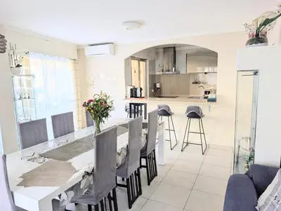 a kitchen and dining room with a long table and chairs at La Providence in Nice
