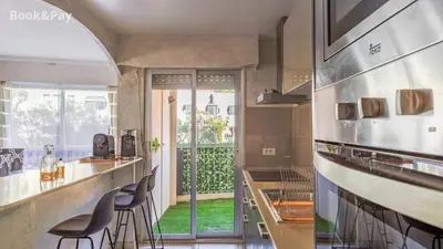 a kitchen with a counter and chairs in a room at La Providence in Nice