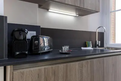 a kitchen with a counter top with a coffee maker on it at Cosy 1 Bdr near Garibaldi Square - Top Floor & AC in Nice