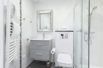 a white bathroom with a sink and a mirror at Cosy 1 Bdr near Garibaldi Square - Top Floor & AC in Nice