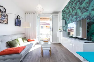 a living room with a couch and a tv at Cosy 1 Bdr near Garibaldi Square - Top Floor & AC in Nice