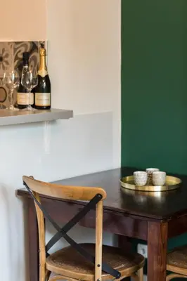 a table with a chair and a bottle of wine at Beautiful apartment in the heart of Nice in Nice