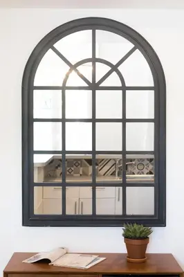 an arched window above a desk with a plant at Beautiful apartment in the heart of Nice in Nice