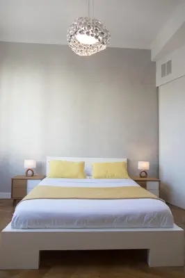 a bedroom with a large bed with a chandelier at Beautiful apartment in the heart of Nice in Nice