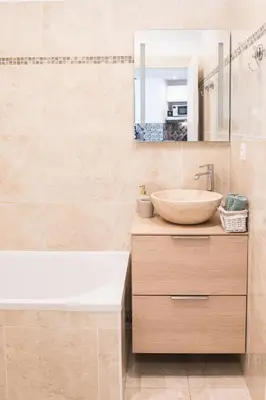 a bathroom with a sink and a tub and a mirror at Beautiful apartment in the heart of Nice in Nice