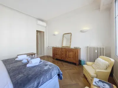 a room with a bed and a chair and a mirror at Nestor&Jeeves - HORIZON PROMENADE - Central - Sea front in Nice