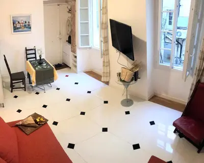 a living room with a white and black floor at Apartment Claudia - Central -Quiet- Near the Sea- AC- Private Parking in Nice