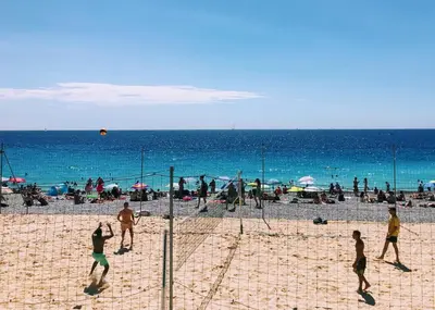 a group of people playing volleyball on a beach at Apartment Claudia - Central -Quiet- Near the Sea- AC- Private Parking in Nice
