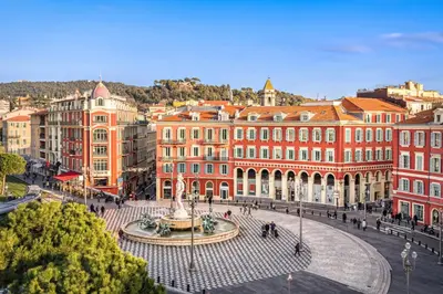 a city with a fountain in front of buildings at Apartment Claudia - Central -Quiet- Near the Sea- AC- Private Parking in Nice
