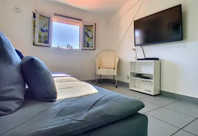 a living room with a couch and a flat screen tv at Nestor&Jeeves - POP RETRO - Central - By sea in Nice