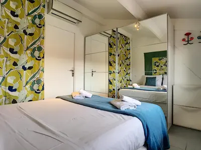 a bedroom with two beds and a mirror at Nestor&Jeeves - POP RETRO - Central - By sea in Nice