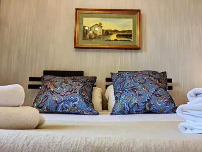 a bed with two pillows and a picture on the wall at Nestor&Jeeves - ANGEL'S BAY - City center - Close beaches in Nice