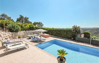 a swimming pool with a table and a bench at Amazing Home In Cagnes Sur Mer in Cagnes-sur-Mer
