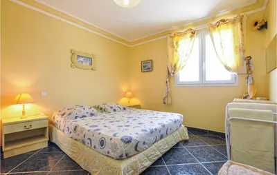a bedroom with a bed and a window at Amazing Home In Cagnes Sur Mer in Cagnes-sur-Mer