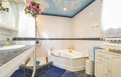 a bathroom with a tub and a sink at Amazing Home In Cagnes Sur Mer in Cagnes-sur-Mer