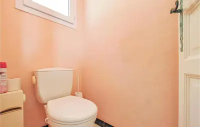 a bathroom with a white toilet and a window at Amazing Home In Cagnes Sur Mer in Cagnes-sur-Mer