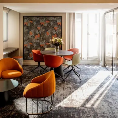 a dining room with a table and chairs at Hôtel Vendôme in Nice