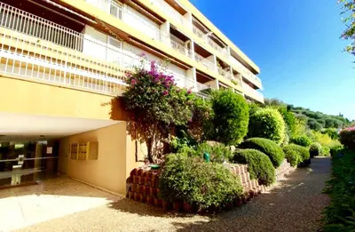 a building with a bunch of bushes next to a building at Paradise view in Villefranche-sur-Mer