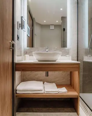 a bathroom with a sink and a shower at Radisson Hotel Nice Airport in Nice