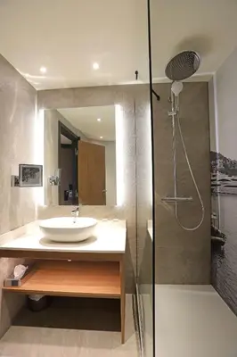 a bathroom with a sink and a shower at Radisson Hotel Nice Airport in Nice
