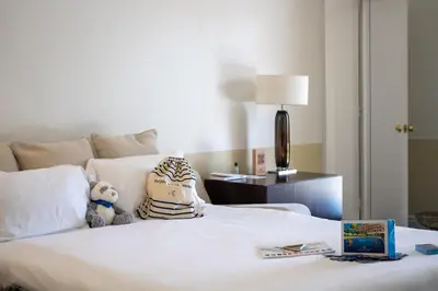 a teddy bear sitting on top of a bed at Hotel Royal-Riviera in Saint-Jean-Cap-Ferrat