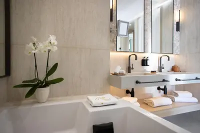 a bathroom with a large white tub and a sink at Hotel Royal-Riviera in Saint-Jean-Cap-Ferrat