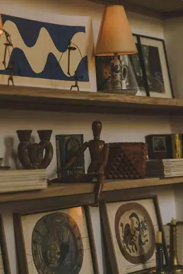 a shelf with pictures and a lamp on it at HOTEL AMOUR NICE in Nice