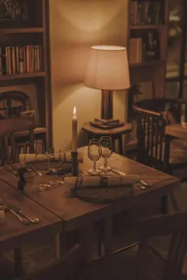 a table with a candle and wine glasses on it at HOTEL AMOUR NICE in Nice