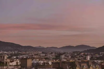 a view of a city with mountains in the background at HOTEL AMOUR NICE in Nice