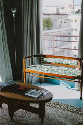 a bed and a coffee table in a room with a window at HOTEL AMOUR NICE in Nice