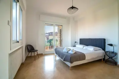 a bedroom with a bed and a large window at Villa Primavera Splendid villa with sea view in Saint-Jean Cap Ferrat in Saint-Jean-Cap-Ferrat