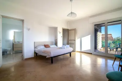 a bedroom with a bed and a large window at Villa Primavera Splendid villa with sea view in Saint-Jean Cap Ferrat in Saint-Jean-Cap-Ferrat