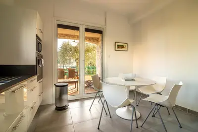 a kitchen with a table and chairs in a room at Villa Primavera Splendid villa with sea view in Saint-Jean Cap Ferrat in Saint-Jean-Cap-Ferrat