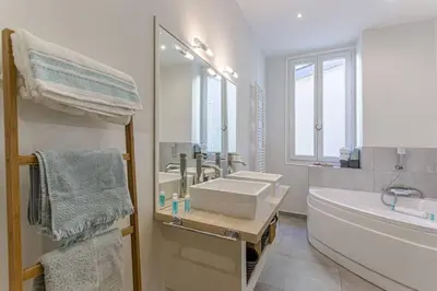 a white bathroom with a tub and a sink and a bath tub at MY CASA - GAMBETTA - Charming 2 bedroom - Near Promenade in Nice