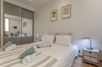 a bedroom with a large bed with two pillows on it at MY CASA - GAMBETTA - Charming 2 bedroom - Near Promenade in Nice