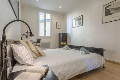 a bedroom with a large white bed with pillows at MY CASA - GAMBETTA - Charming 2 bedroom - Near Promenade in Nice