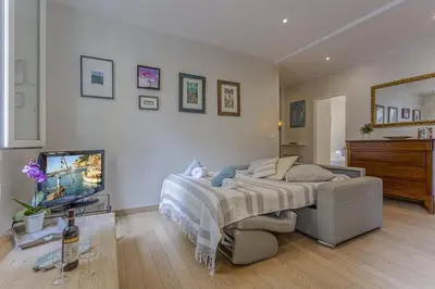 a bedroom with a large bed and a television at MY CASA - GAMBETTA - Charming 2 bedroom - Near Promenade in Nice
