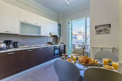 a kitchen with a table with food on it at MY CASA - VICTOR HUGO - Beautiful Apartment - View over Garden in Nice