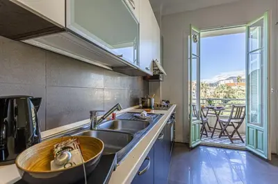 a kitchen with a sink and a large window at MY CASA - VICTOR HUGO - Beautiful Apartment - View over Garden in Nice