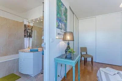 a bathroom with a sink and a table with a lamp at MY CASA - PALAIS MED - Palais Méditerranéen - Panoramic view in Nice