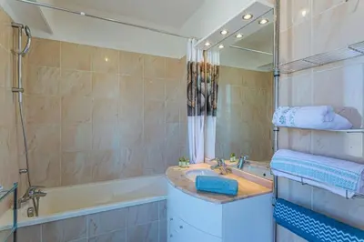 a bathroom with a sink and a tub and a mirror at MY CASA - PALAIS MED - Palais Méditerranéen - Panoramic view in Nice