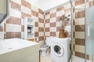 a bathroom with a washing machine and a toilet at Cosy Studio at Nice Port in Nice